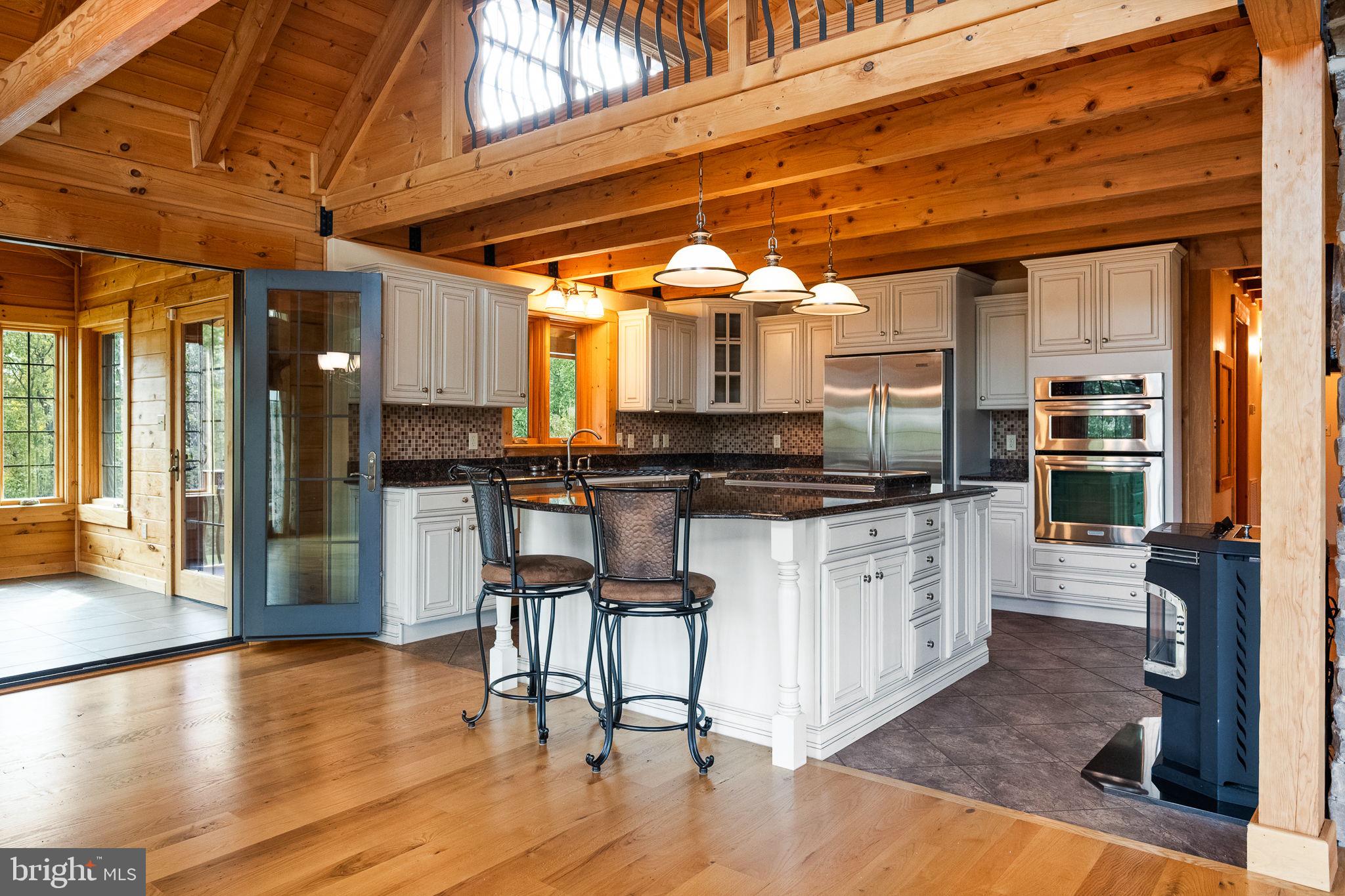 447 Fable Road Hedgesville, WV 25427 - Photo 16 of 81 a kitchen with granite countertop a stove and white cabinets