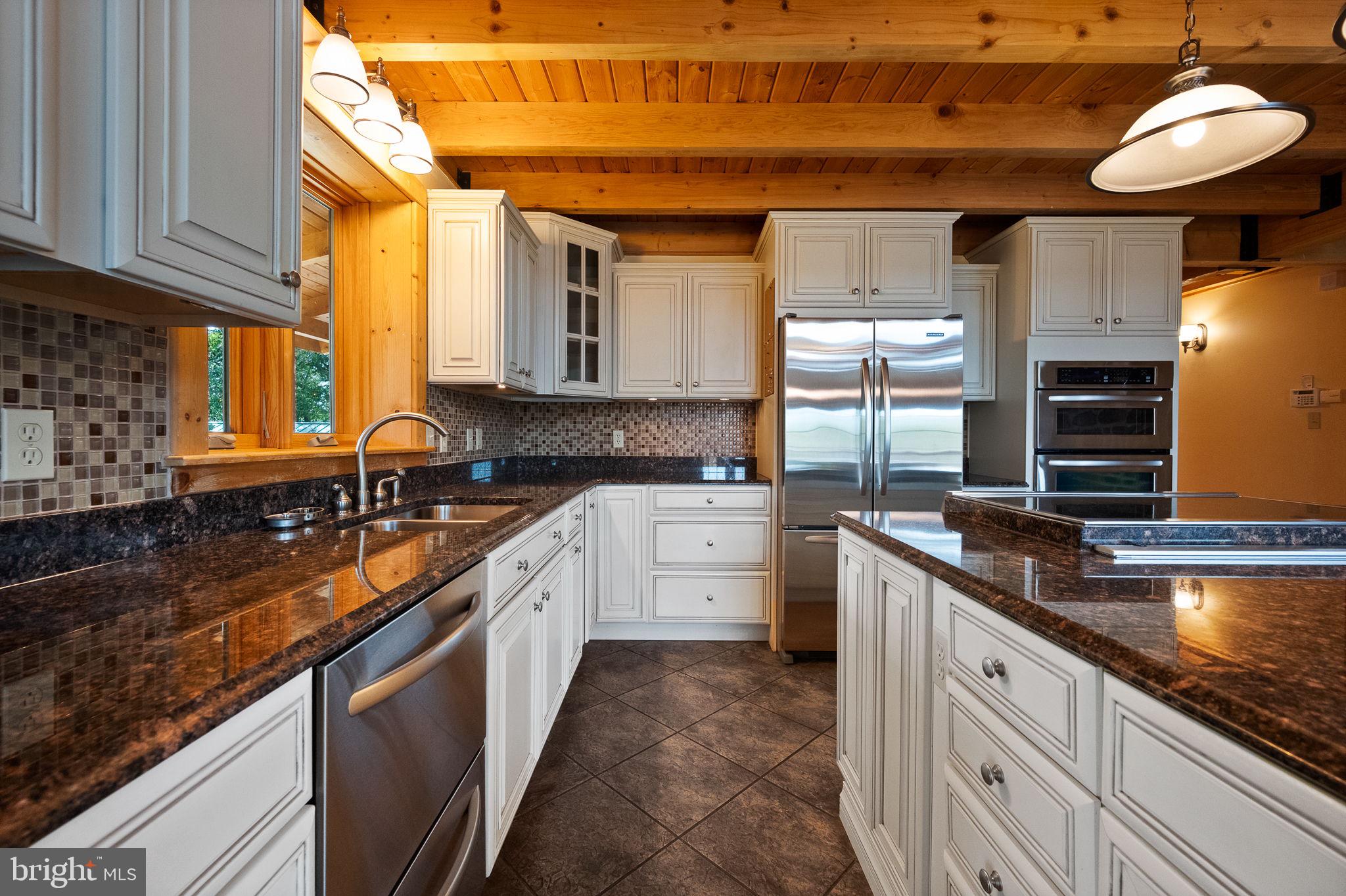447 Fable Road Hedgesville, WV 25427 - Photo 18 of 81 a large kitchen with stainless steel appliances granite countertop a sink a stove and a wooden cabinets