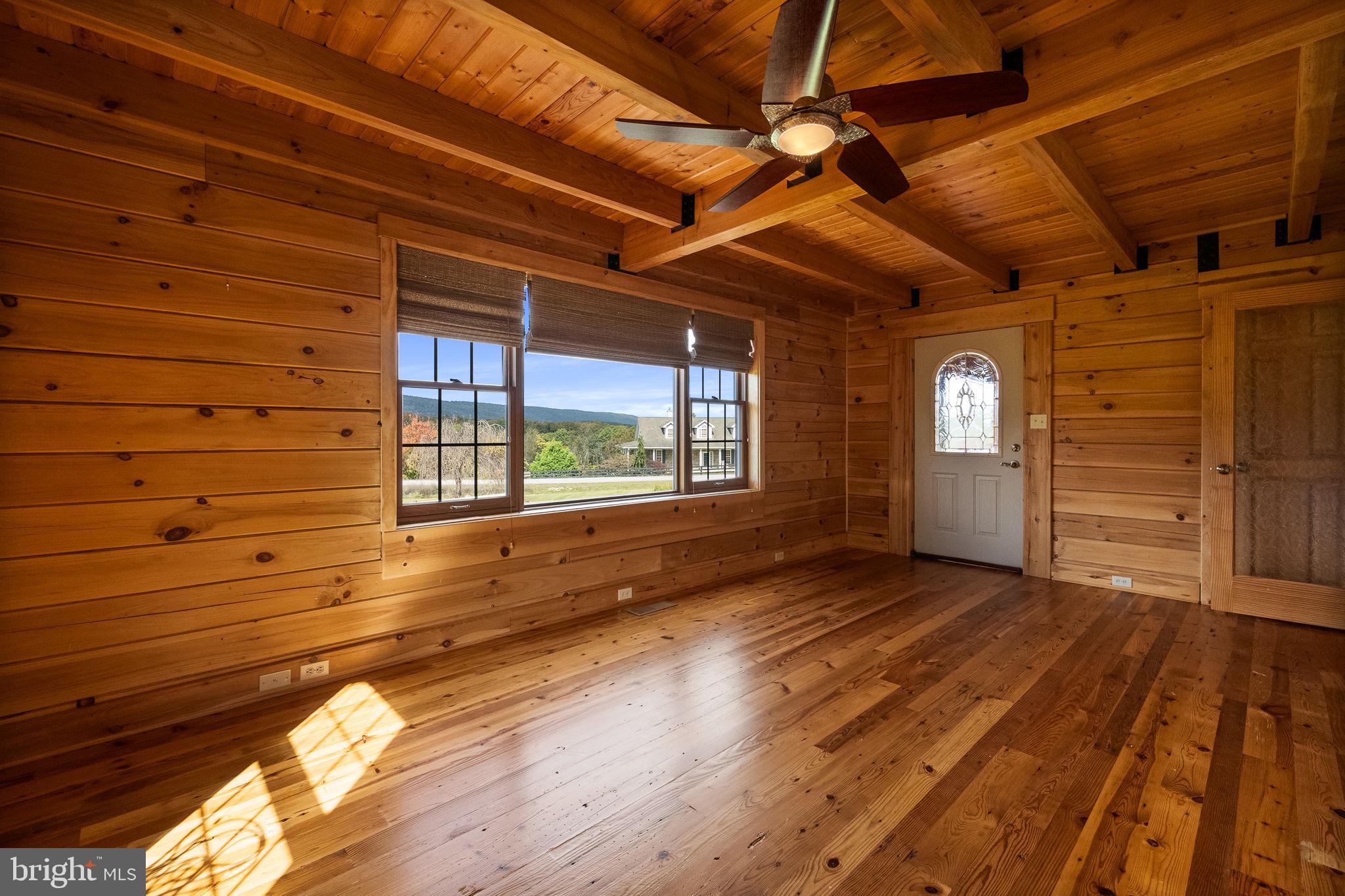 447 Fable Road Hedgesville, WV 25427 - Photo 30 of 81 a view of empty room with wooden floor and fan
