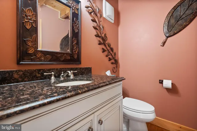 a view of kitchen with granite countertop cabinets and wooden floor