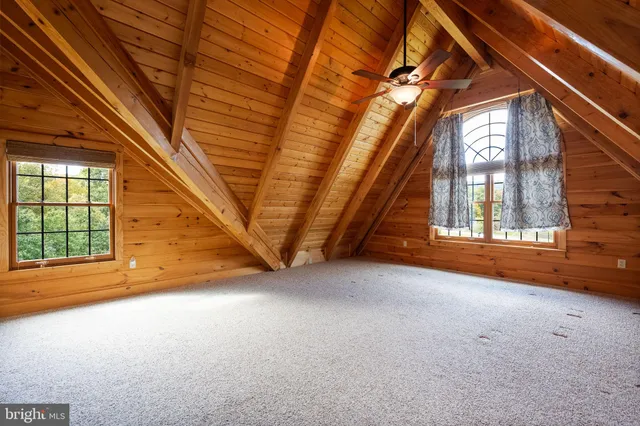 an empty room with closet and windows
