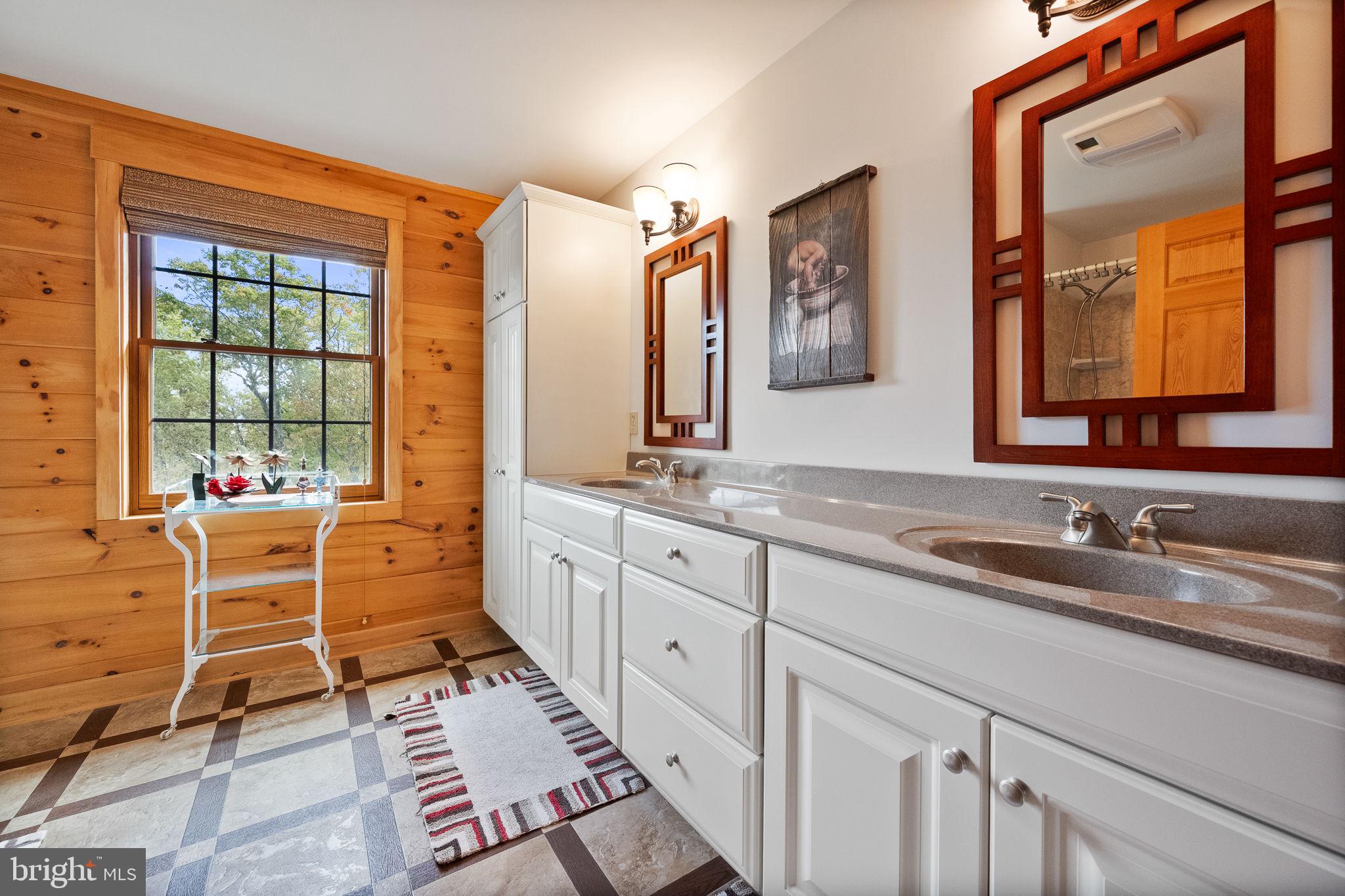 447 Fable Road Hedgesville, WV 25427 - Photo 38 of 81 a spacious bathroom with a double vanity sink a mirror and a shower
