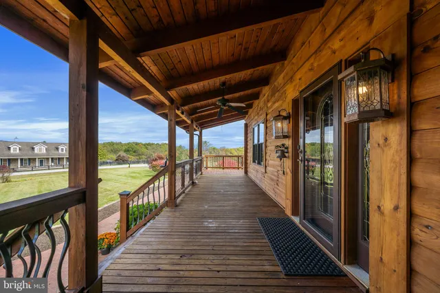 a view of a balcony with wooden floor and iron stairs