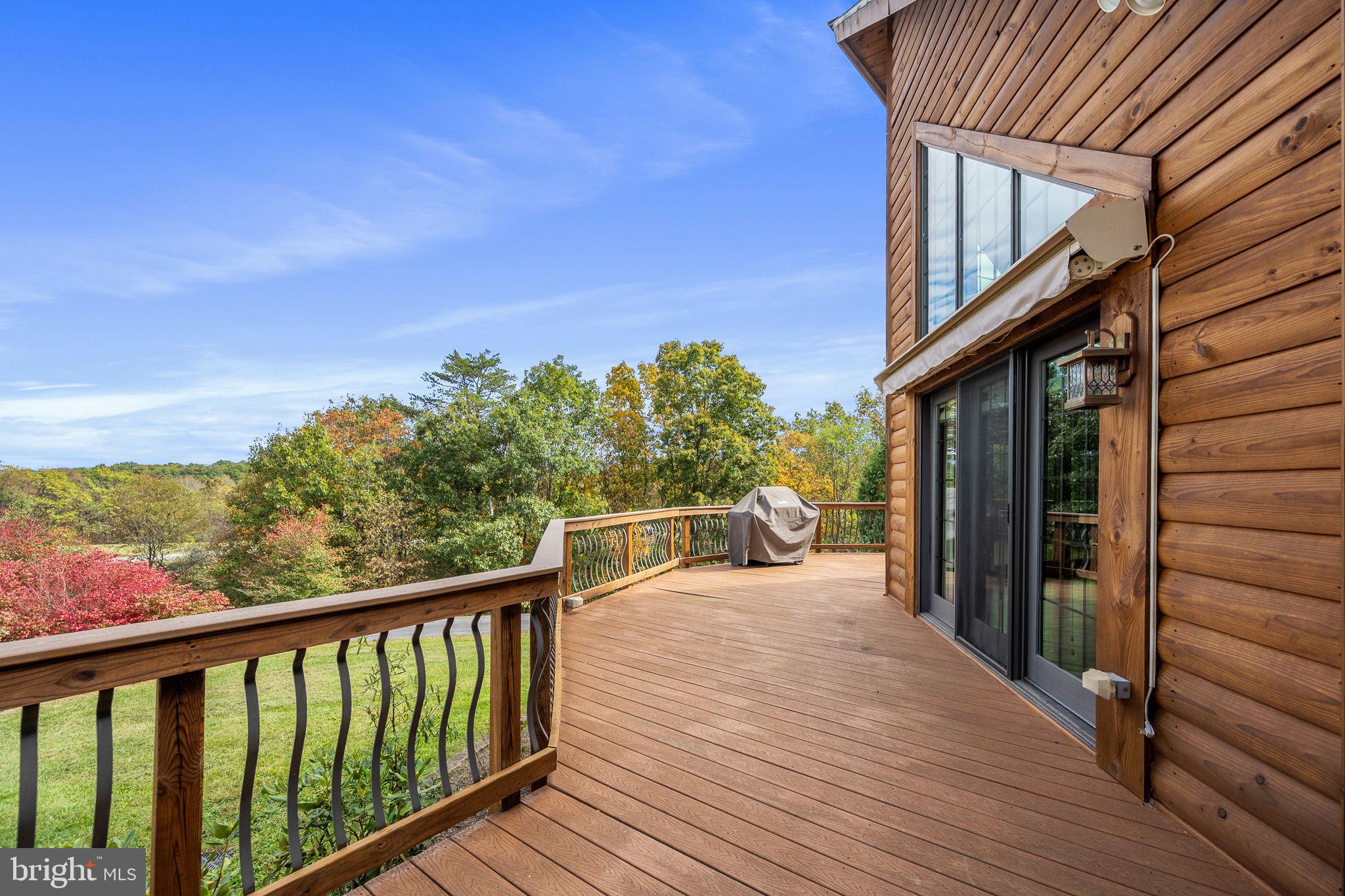 447 Fable Road Hedgesville, WV 25427 - Photo 7 of 81 a view of a balcony with wooden floor and fence