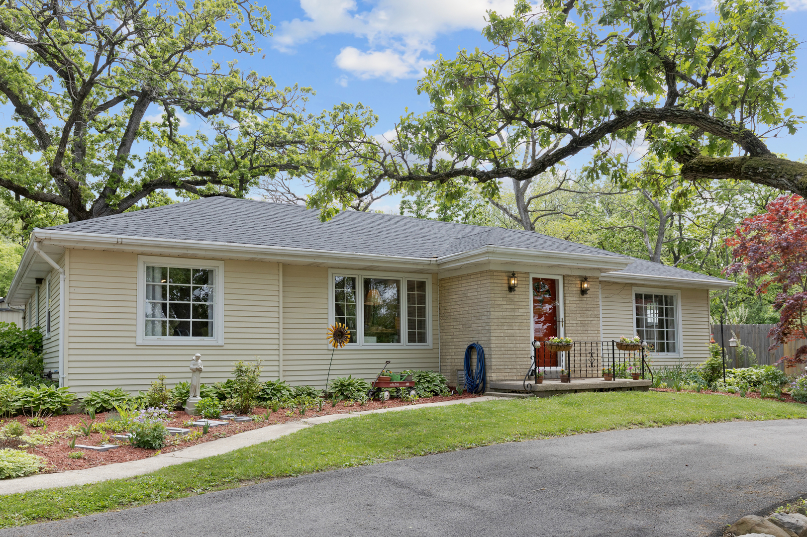 a front view of a house with a yard and a bike