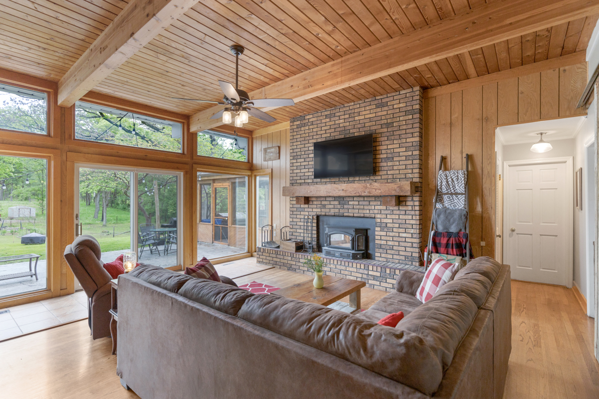 4604 Sunnyside Road Woodstock, IL 60098 - Photo 13 of 37 a living room with fireplace furniture and a large window