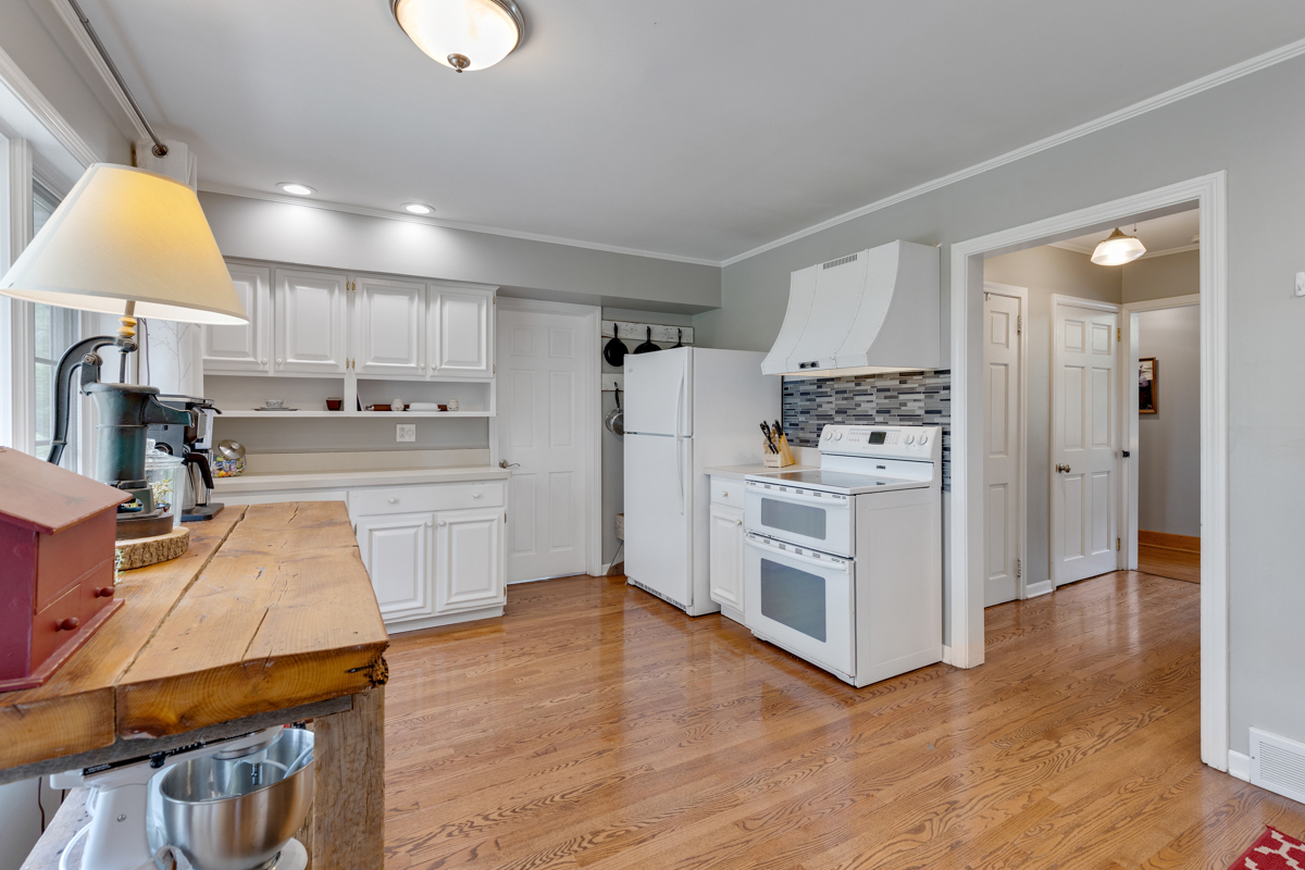 4604 Sunnyside Road Woodstock, IL 60098 - Photo 14 of 37 a kitchen with stainless steel appliances a stove a sink a refrigerator white cabinets and wooden floor