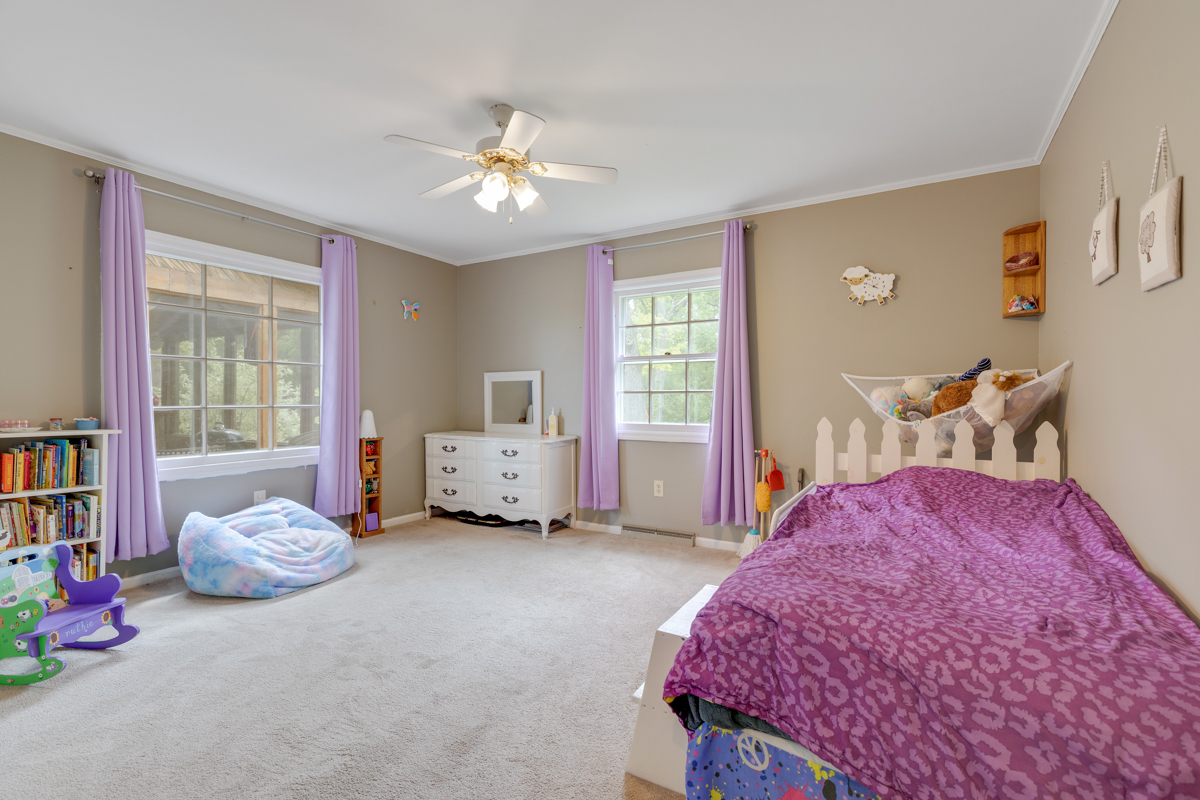 4604 Sunnyside Road Woodstock, IL 60098 - Photo 15 of 37 a bedroom with a bed and a chandelier