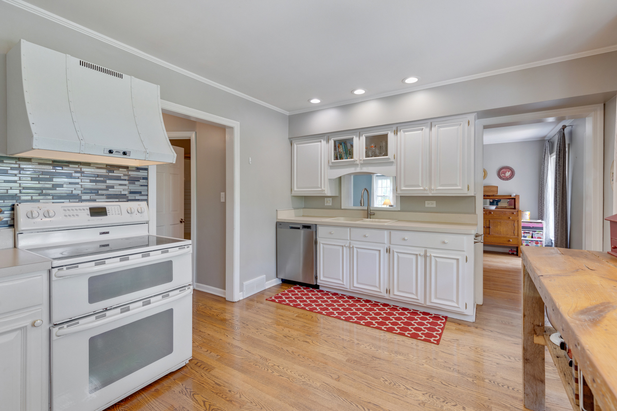 4604 Sunnyside Road Woodstock, IL 60098 - Photo 17 of 37 a kitchen with granite countertop white cabinets and appliances