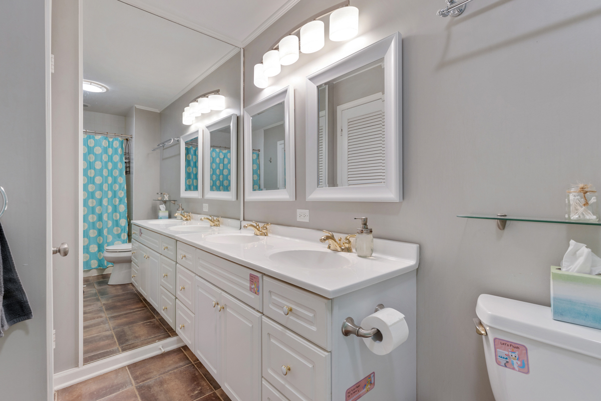 4604 Sunnyside Road Woodstock, IL 60098 - Photo 18 of 37 a spacious bathroom with a double vanity sink a mirror and a toilet