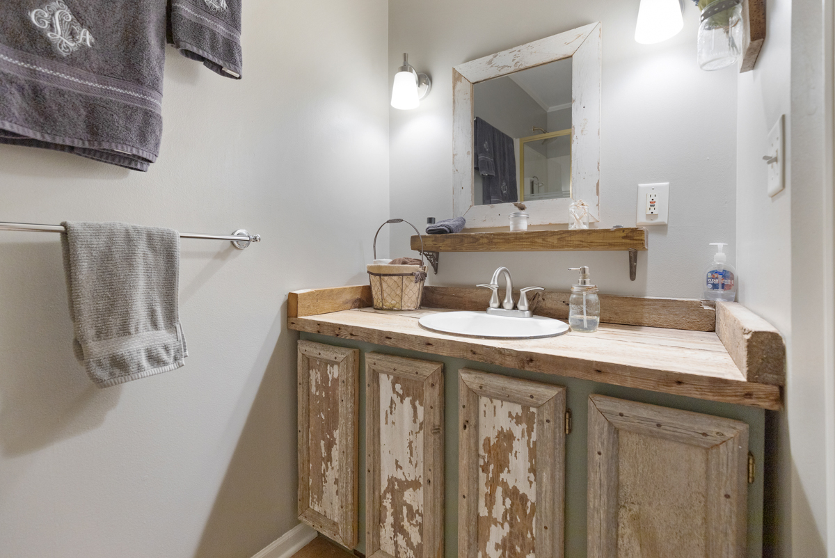 4604 Sunnyside Road Woodstock, IL 60098 - Photo 19 of 37 a bathroom with a granite countertop sink and a mirror