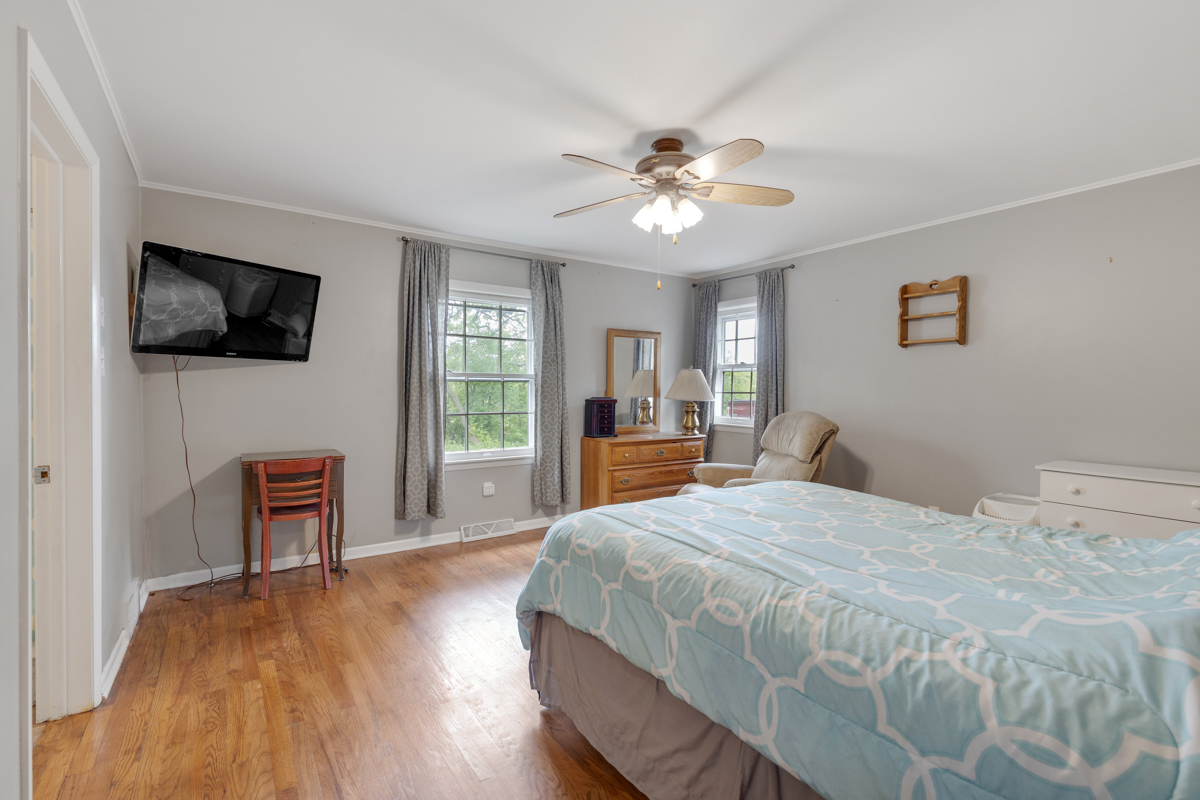 4604 Sunnyside Road Woodstock, IL 60098 - Photo 20 of 37 a spacious bedroom with a bed and a flat screen tv