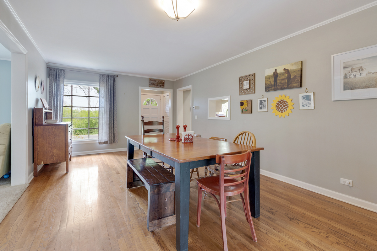 4604 Sunnyside Road Woodstock, IL 60098 - Photo 2 of 37 a view of a dining room with furniture and wooden floor