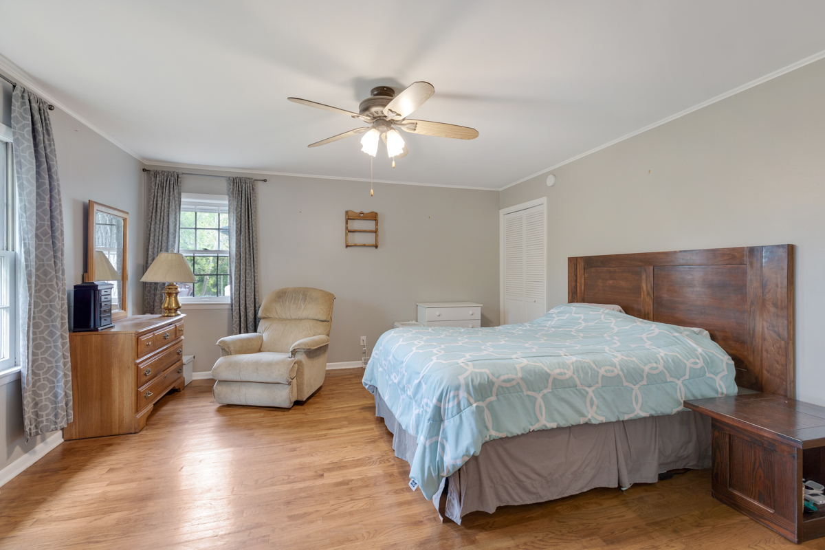 4604 Sunnyside Road Woodstock, IL 60098 - Photo 21 of 37 a bedroom with a bed and wooden floor