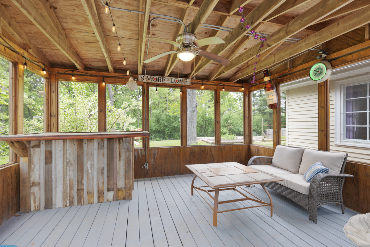 4604 Sunnyside Road Woodstock, IL 60098 - Photo 22 of 37 a living room with furniture floor to ceiling window and wooden floor
