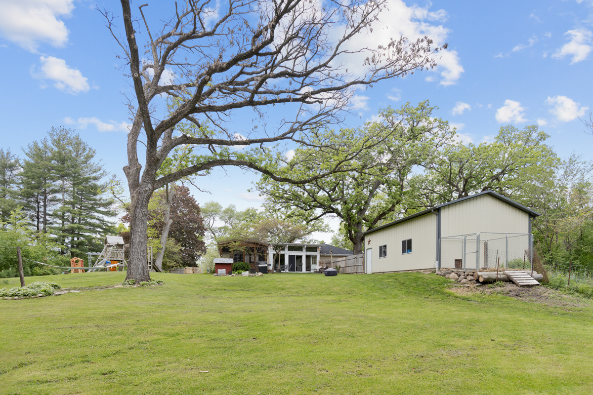 4604 Sunnyside Road Woodstock, IL 60098 - Photo 24 of 37 a front view of house with yard and trees