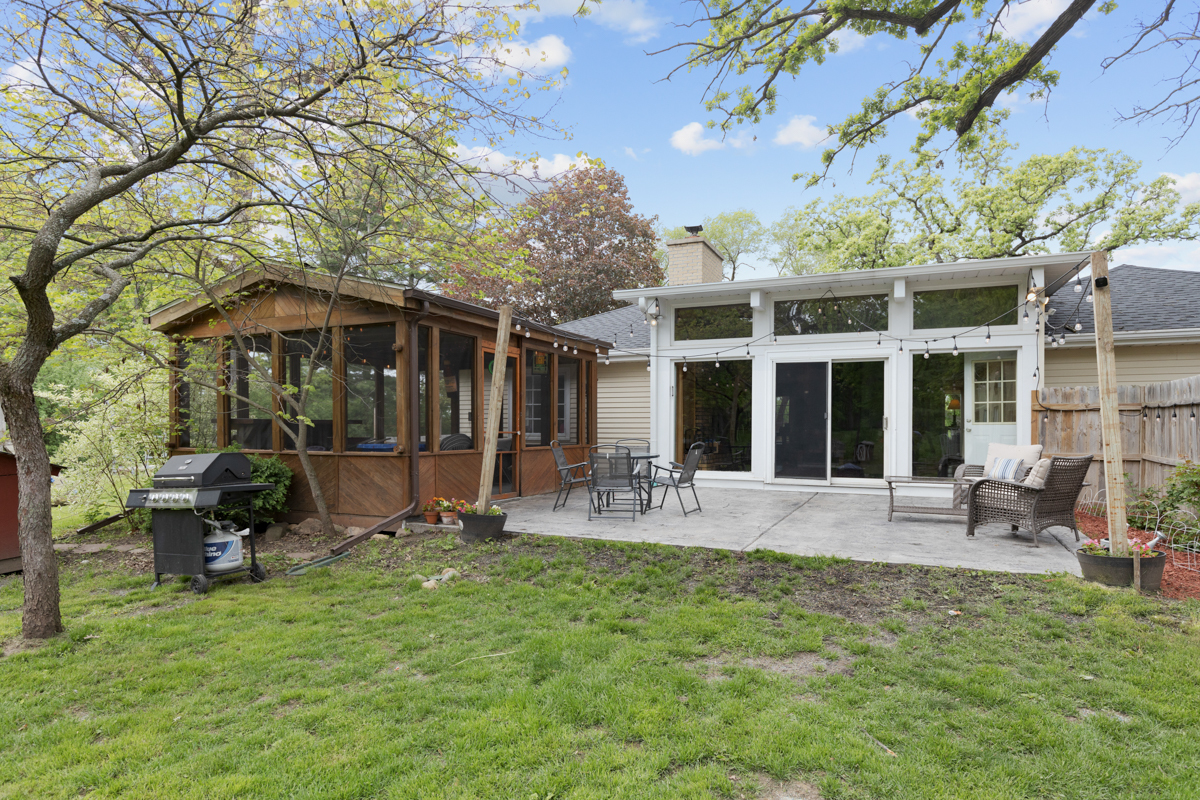 4604 Sunnyside Road Woodstock, IL 60098 - Photo 29 of 37 a view of a house with a patio and a garden