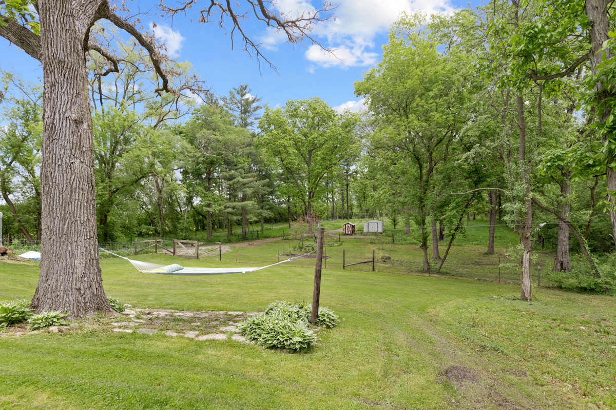 4604 Sunnyside Road Woodstock, IL 60098 - Photo 31 of 37 a view of a yard with a tree
