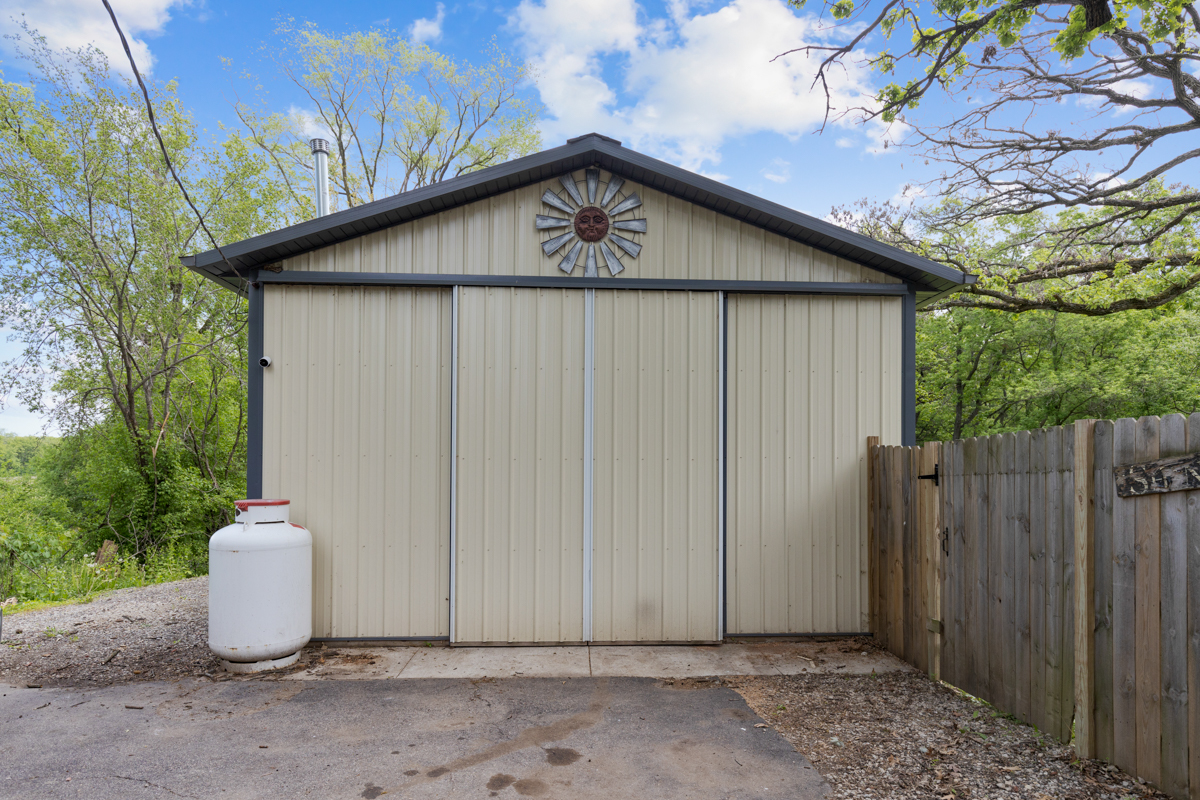4604 Sunnyside Road Woodstock, IL 60098 - Photo 35 of 37 a white house with a small yard plants and large tree