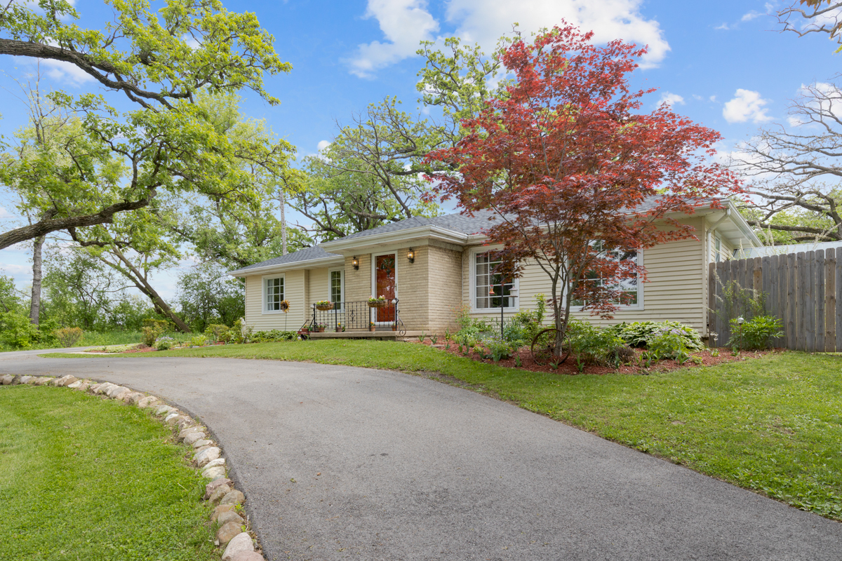 4604 Sunnyside Road Woodstock, IL 60098 - Photo 4 of 37 a front view of a house with a yard and garage