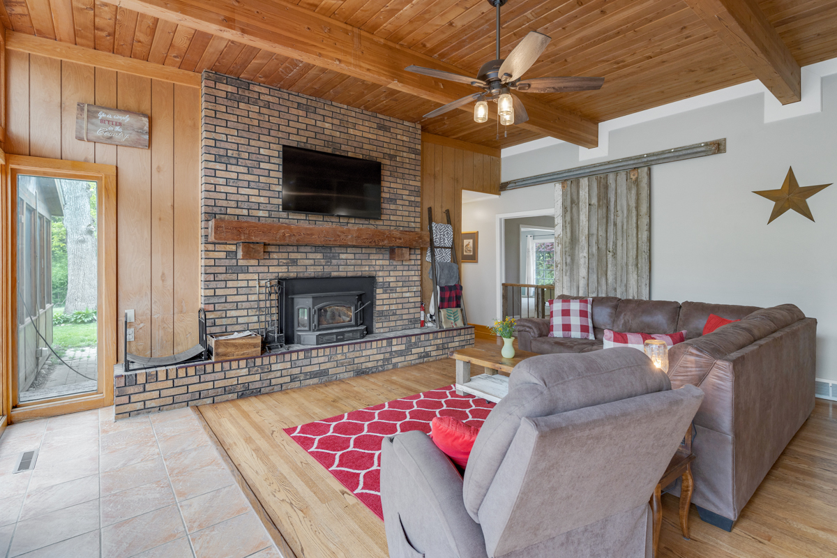 4604 Sunnyside Road Woodstock, IL 60098 - Photo 6 of 37 a living room with furniture a flat screen tv and a fireplace