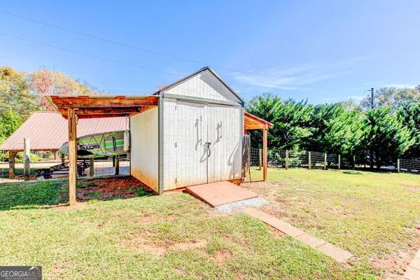 a backyard of a house with table and chairs