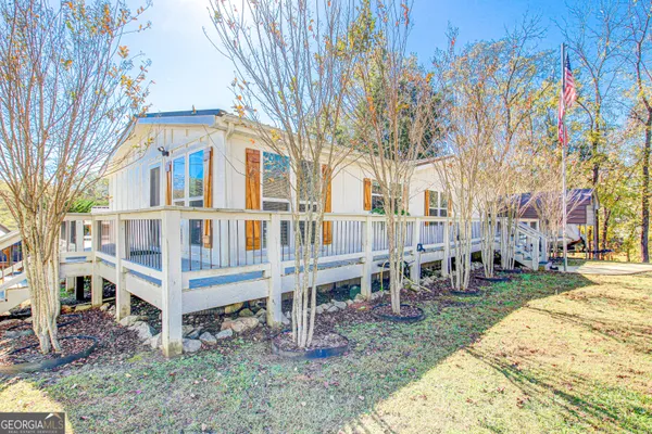 a view of a house with a yard and sitting area