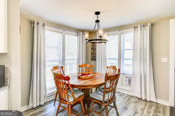 a view of a dining room with furniture window and wooden floor