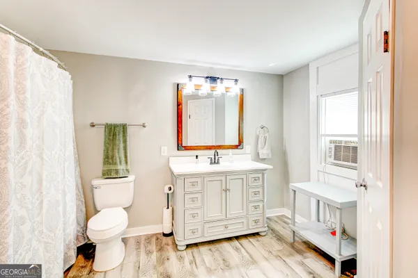 a bathroom with a toilet a sink and a mirror
