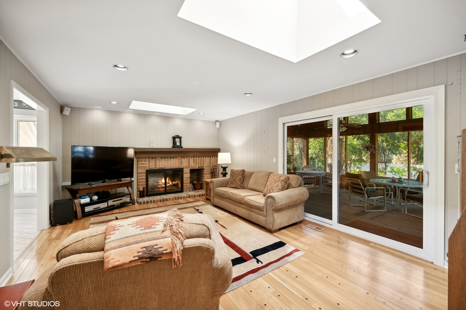 3110 Techny Road Northbrook, IL 60062 - Photo 5 of 21 a living room with furniture a flat screen tv and a fireplace