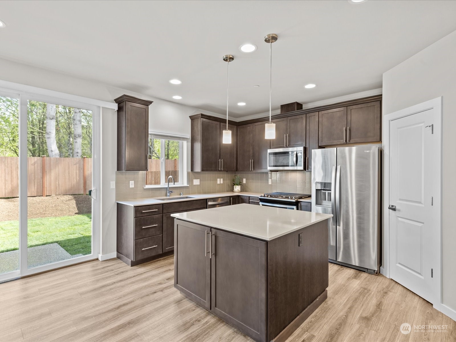 20713 42nd Avenue Southeast, Unit A Bothell, WA 98021 - Photo 13 of 32 a kitchen with kitchen island a sink stainless steel appliances and window