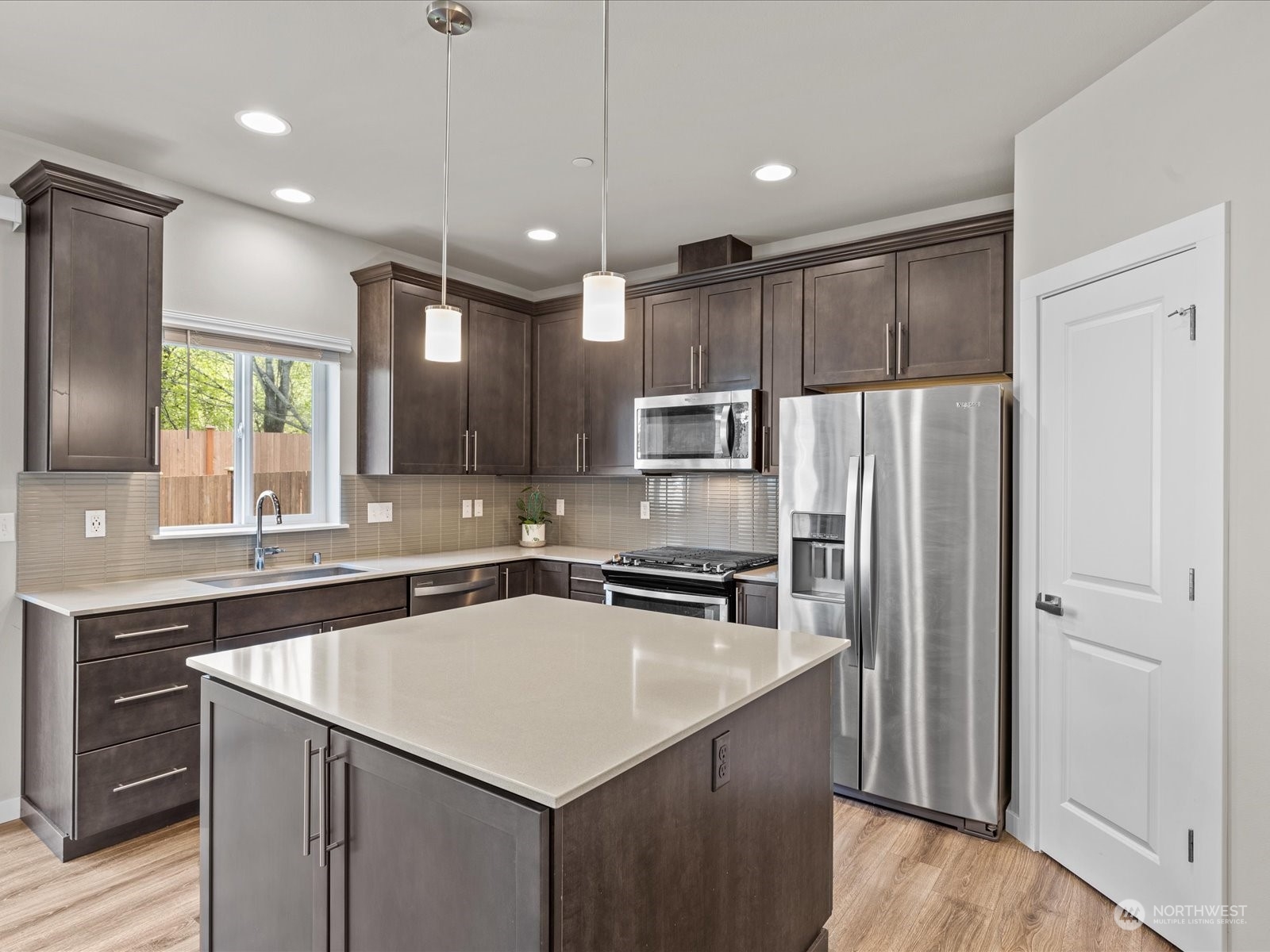 20713 42nd Avenue Southeast, Unit A Bothell, WA 98021 - Photo 14 of 32 a kitchen with kitchen island a sink stainless steel appliances and cabinets