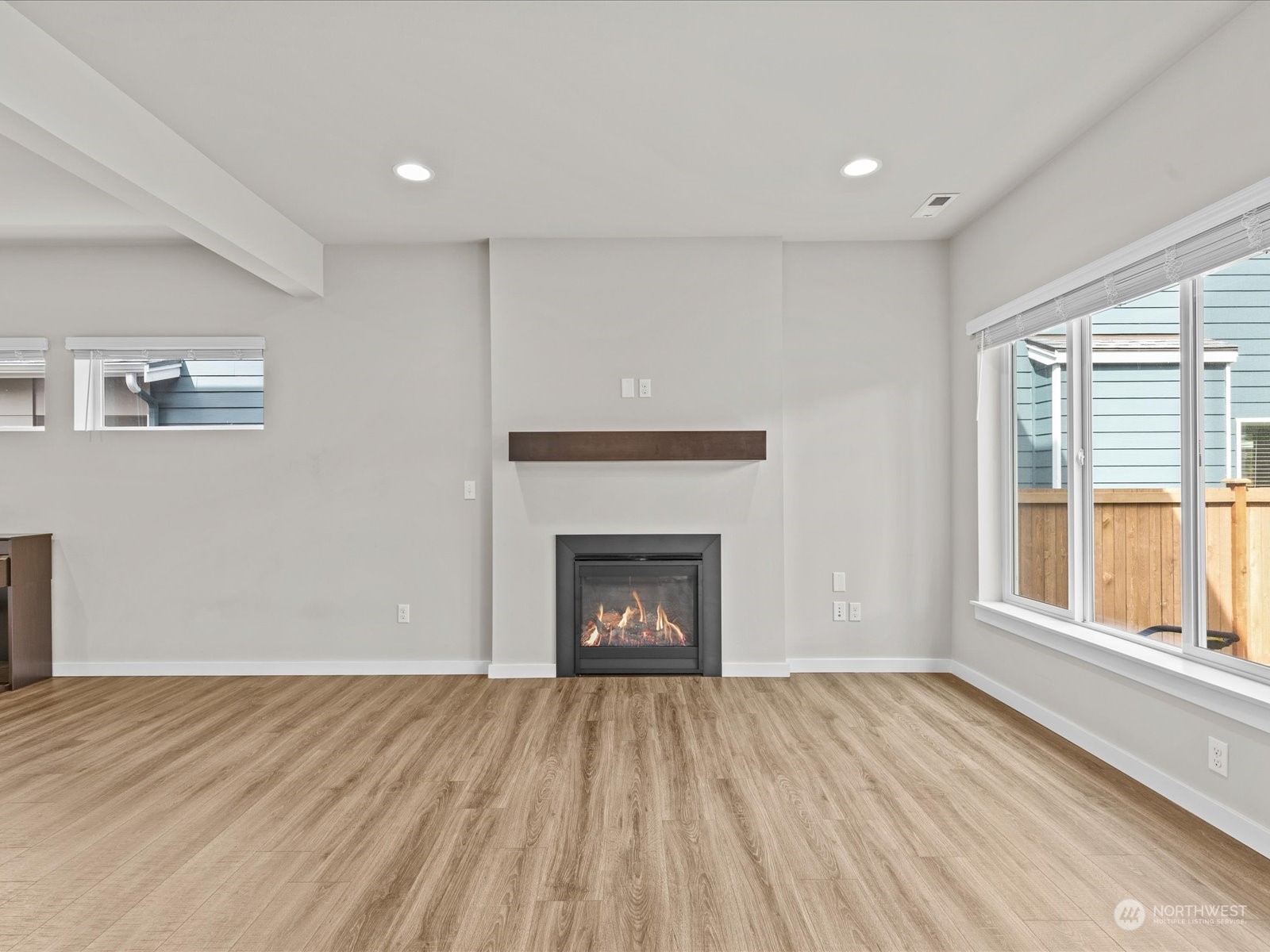 20713 42nd Avenue Southeast, Unit A Bothell, WA 98021 - Photo 17 of 32 a view of an empty room with a fireplace and a window