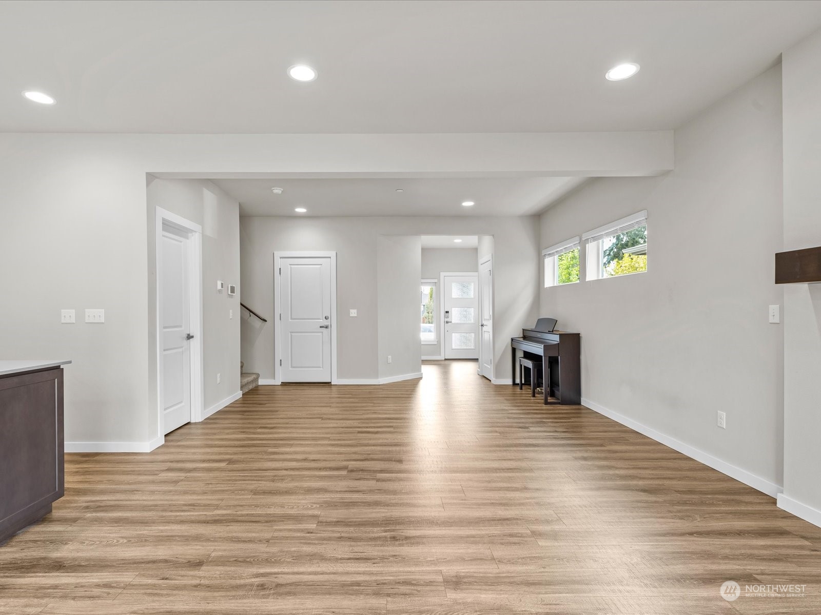 20713 42nd Avenue Southeast, Unit A Bothell, WA 98021 - Photo 18 of 32 a view of an empty room with wooden floor and a kitchen