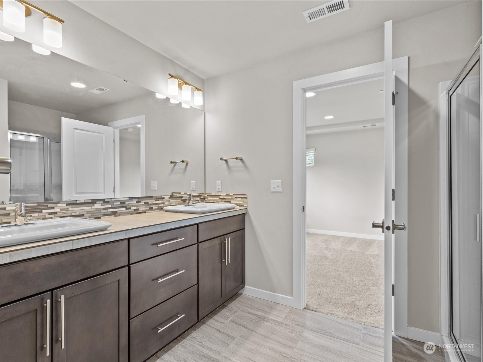 20713 42nd Avenue Southeast, Unit A Bothell, WA 98021 - Photo 22 of 32 a bathroom with a double vanity sink and mirror
