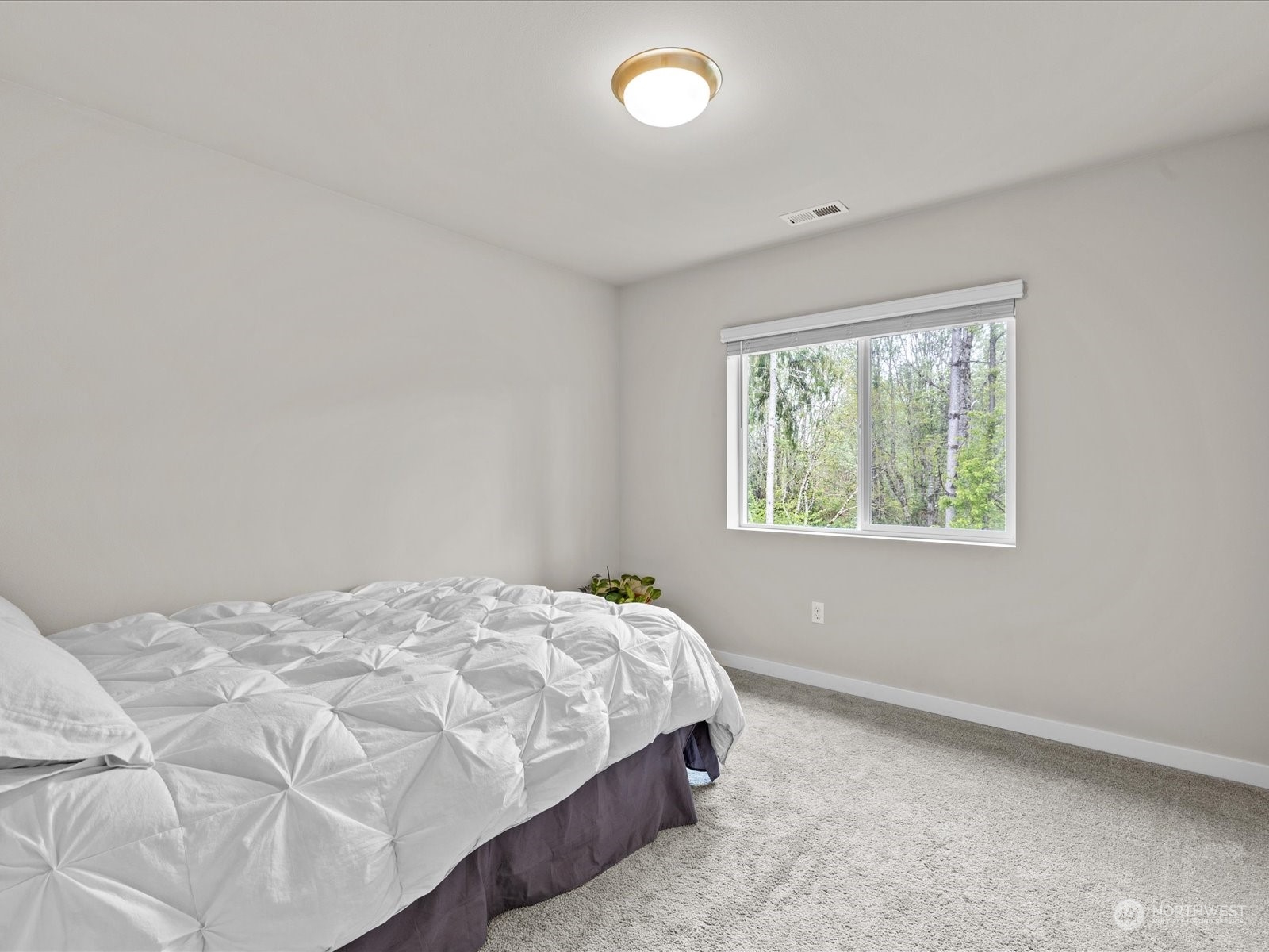 20713 42nd Avenue Southeast, Unit A Bothell, WA 98021 - Photo 24 of 32 a bedroom with a bed and a window