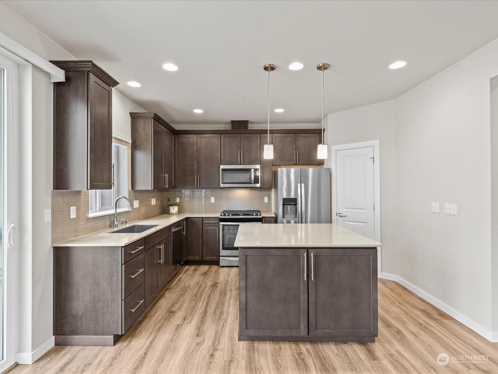 20713 42nd Avenue Southeast, Unit A Bothell, WA 98021 - Photo 3 of 32 a large kitchen with stainless steel appliances granite countertop a large counter top a sink and a stove