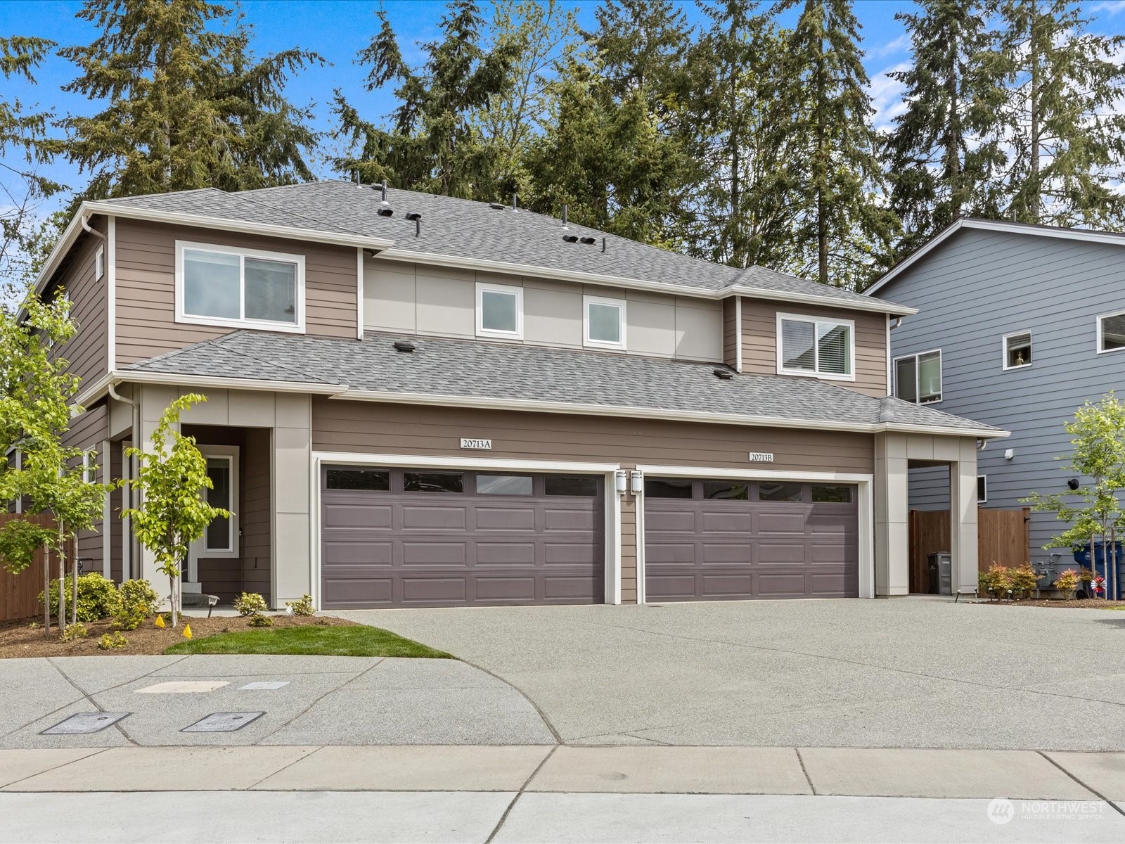 20713 42nd Avenue Southeast, Unit A Bothell, WA 98021 - Photo 31 of 32 a front view of a house with a yard and garage