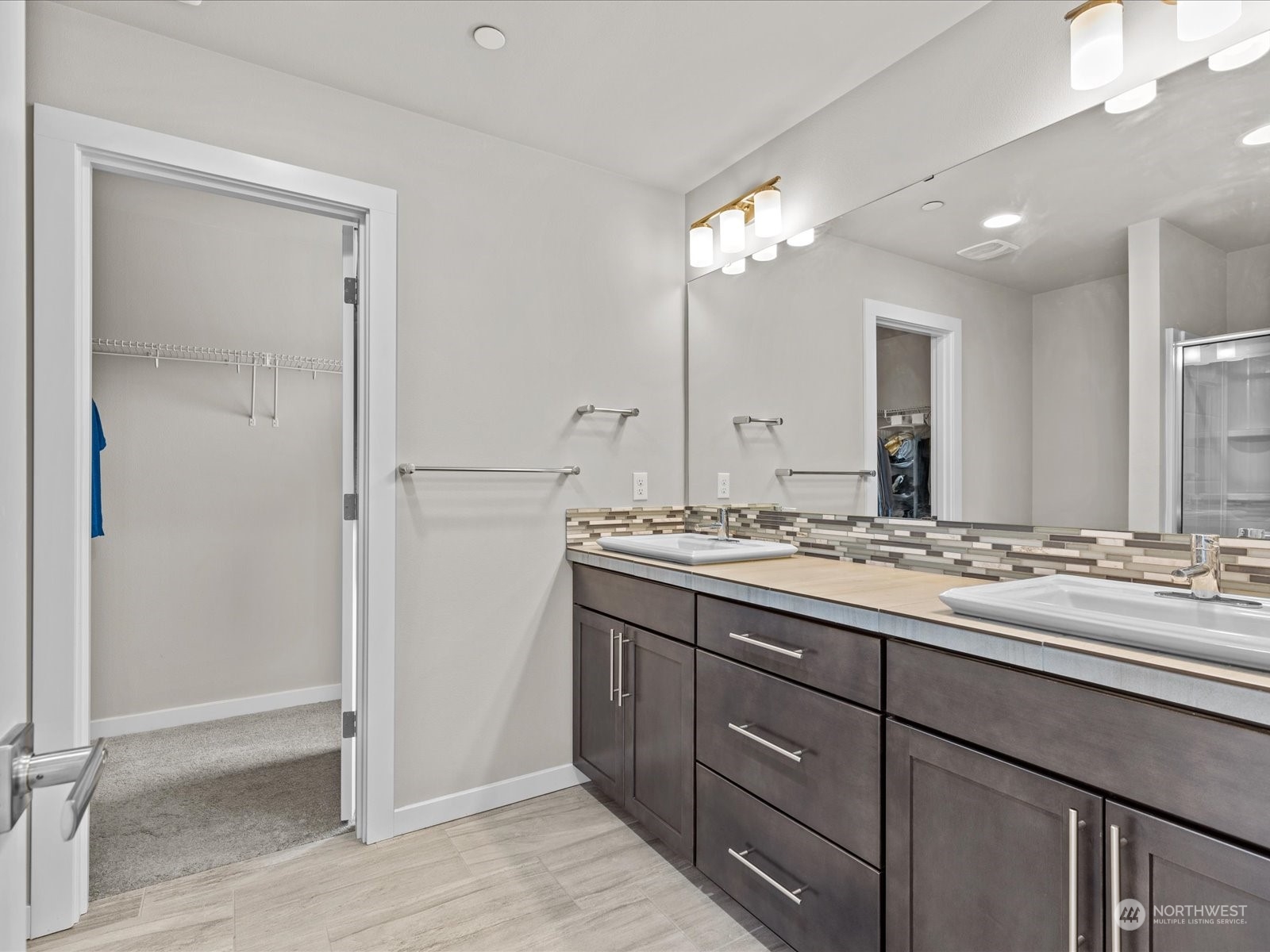 20713 42nd Avenue Southeast, Unit A Bothell, WA 98021 - Photo 5 of 32 a bathroom with a double vanity sink and a mirror