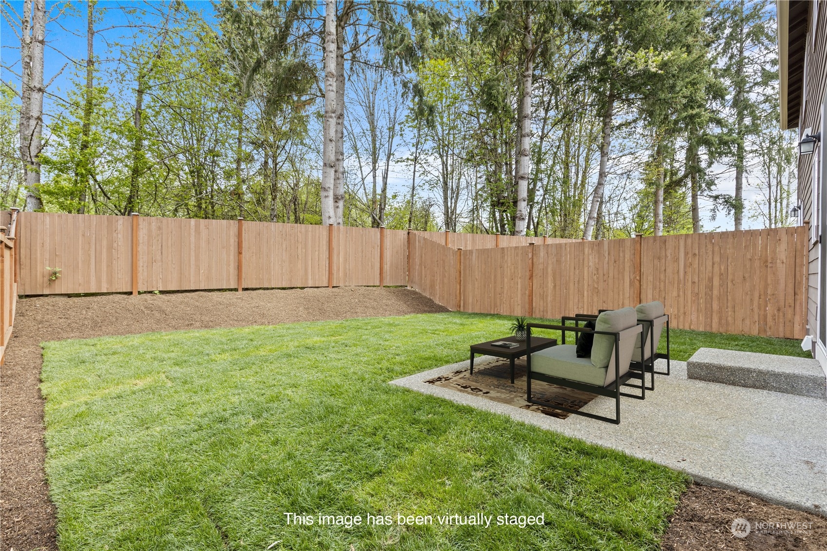 20713 42nd Avenue Southeast, Unit A Bothell, WA 98021 - Photo 7 of 32 a backyard of a house with table and chairs