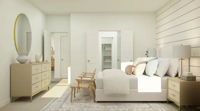 a bedroom with a bed a mirror and lamp