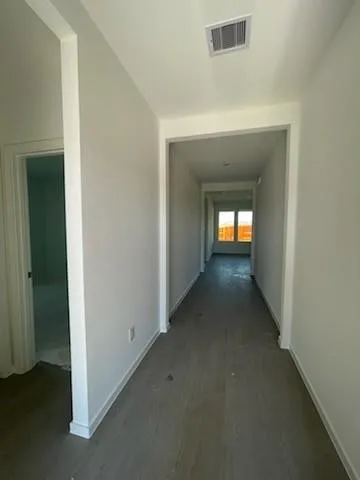 a view of a hallway with a window