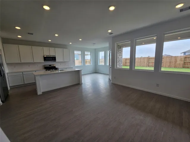 a view of a room with wooden floor