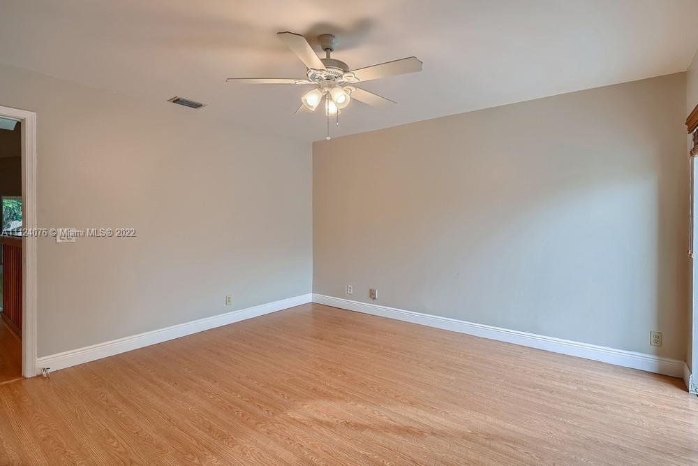 23060 Aqua, Unit 8 Boca Raton, FL 33433 - Photo 14 of 33 a view of an empty room with wooden floor