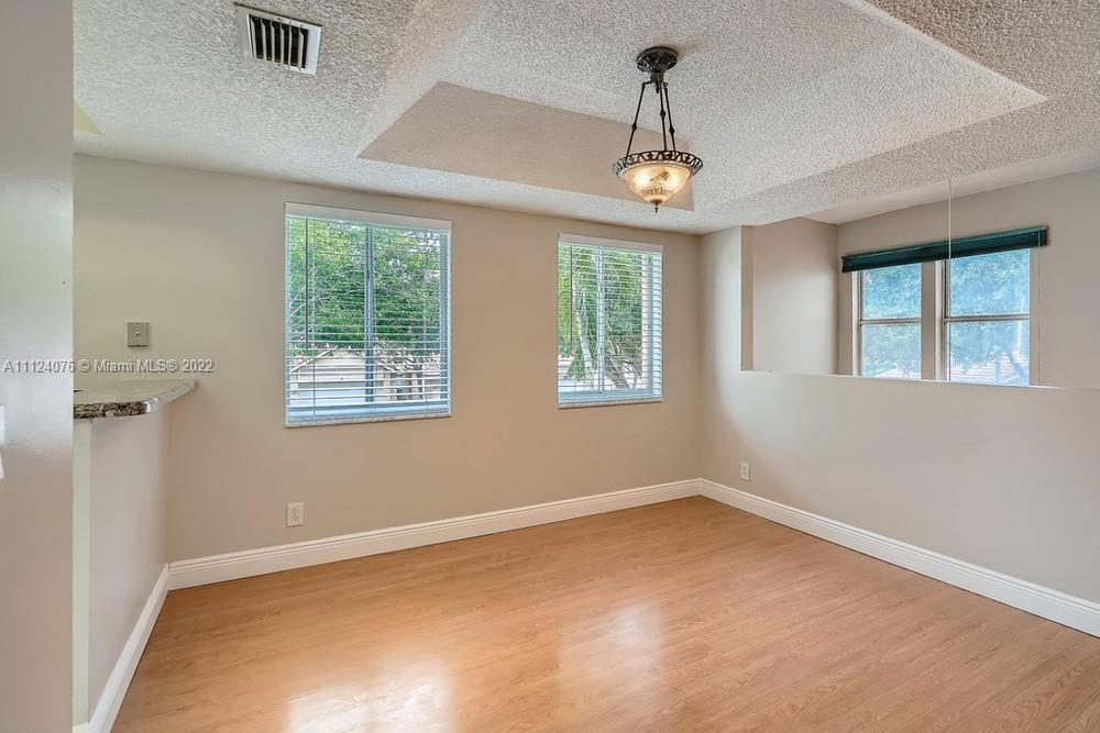 23060 Aqua, Unit 8 Boca Raton, FL 33433 - Photo 17 of 33 wooden floor in an empty room with a window
