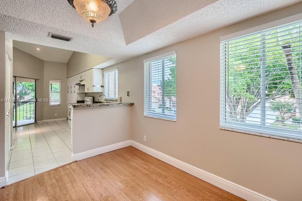 23060 Aqua, Unit 8 Boca Raton, FL 33433 - Photo 18 of 33 a view of a kitchen with microwave and stove