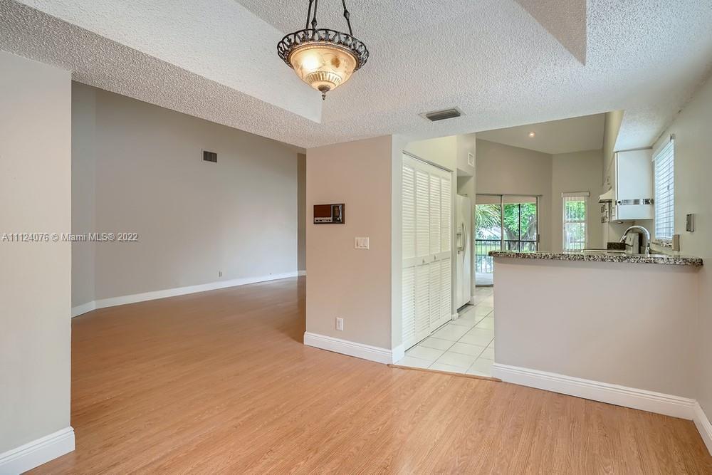 23060 Aqua, Unit 8 Boca Raton, FL 33433 - Photo 19 of 33 an empty room with kitchen and windows