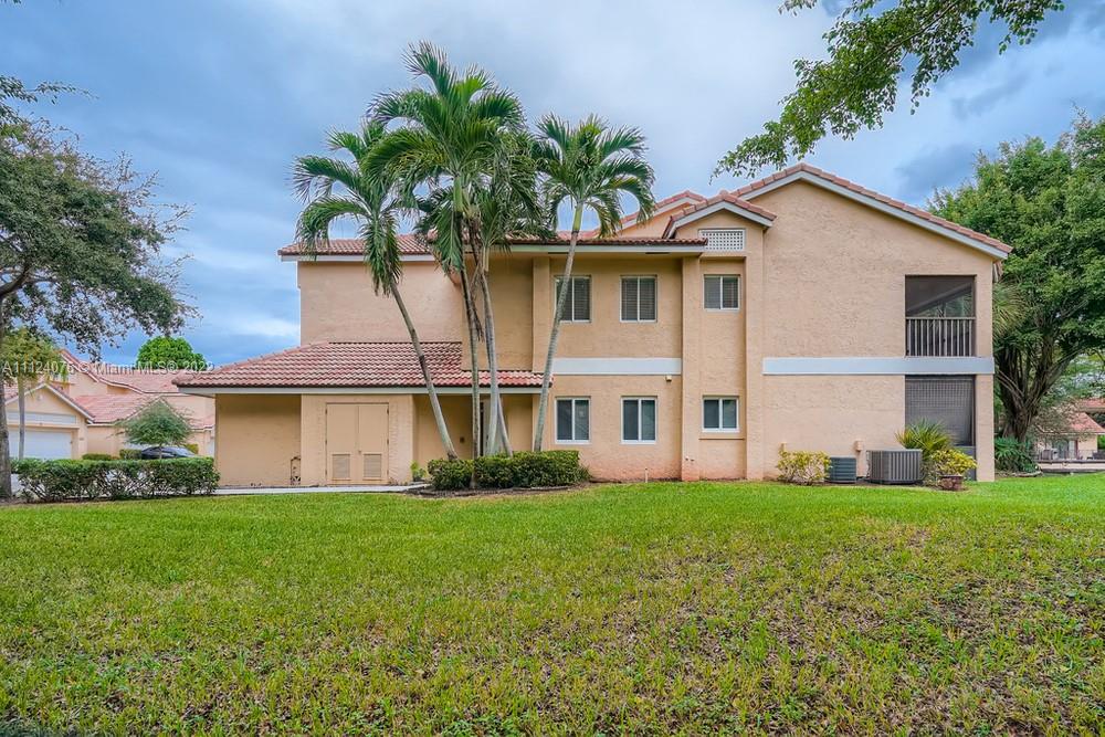 23060 Aqua, Unit 8 Boca Raton, FL 33433 - Photo 2 of 33 a front view of house with yard and green space