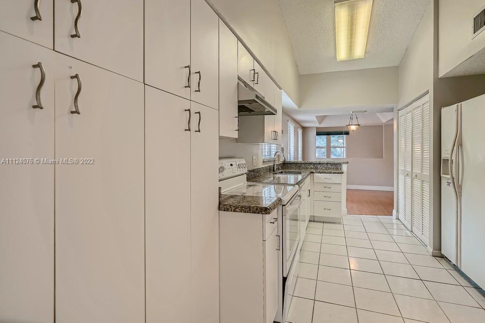 23060 Aqua, Unit 8 Boca Raton, FL 33433 - Photo 21 of 33 a kitchen with stainless steel appliances granite countertop a refrigerator and a sink