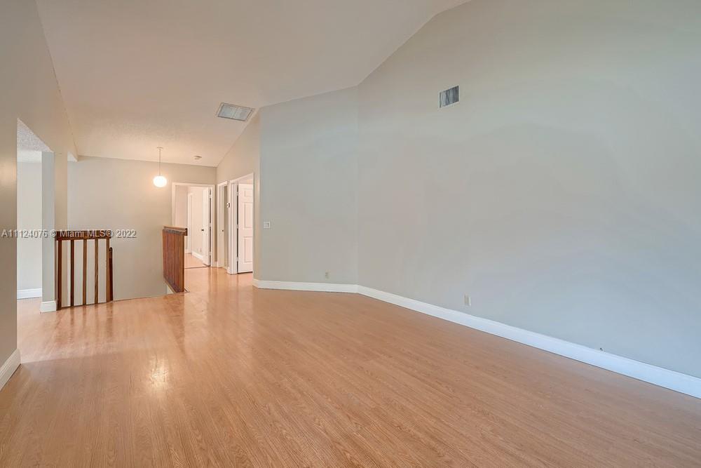 23060 Aqua, Unit 8 Boca Raton, FL 33433 - Photo 24 of 33 a view of a hallway with wooden floor